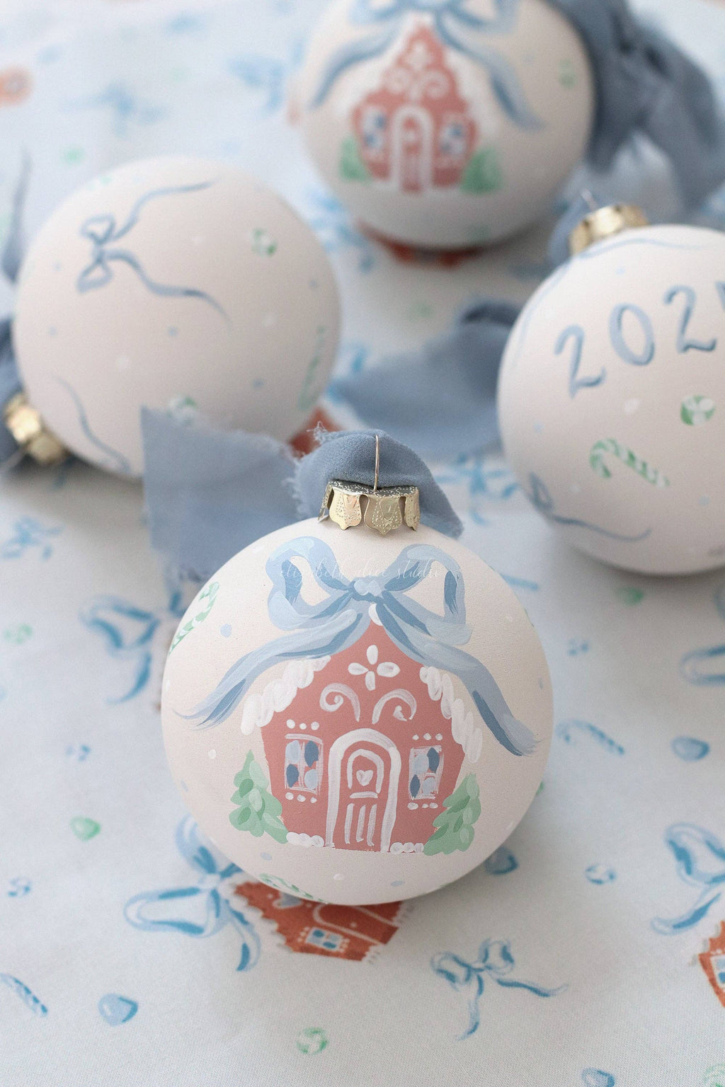 Blue gingerbread house hand-painted ornament: No year (bows and candy on reverse)