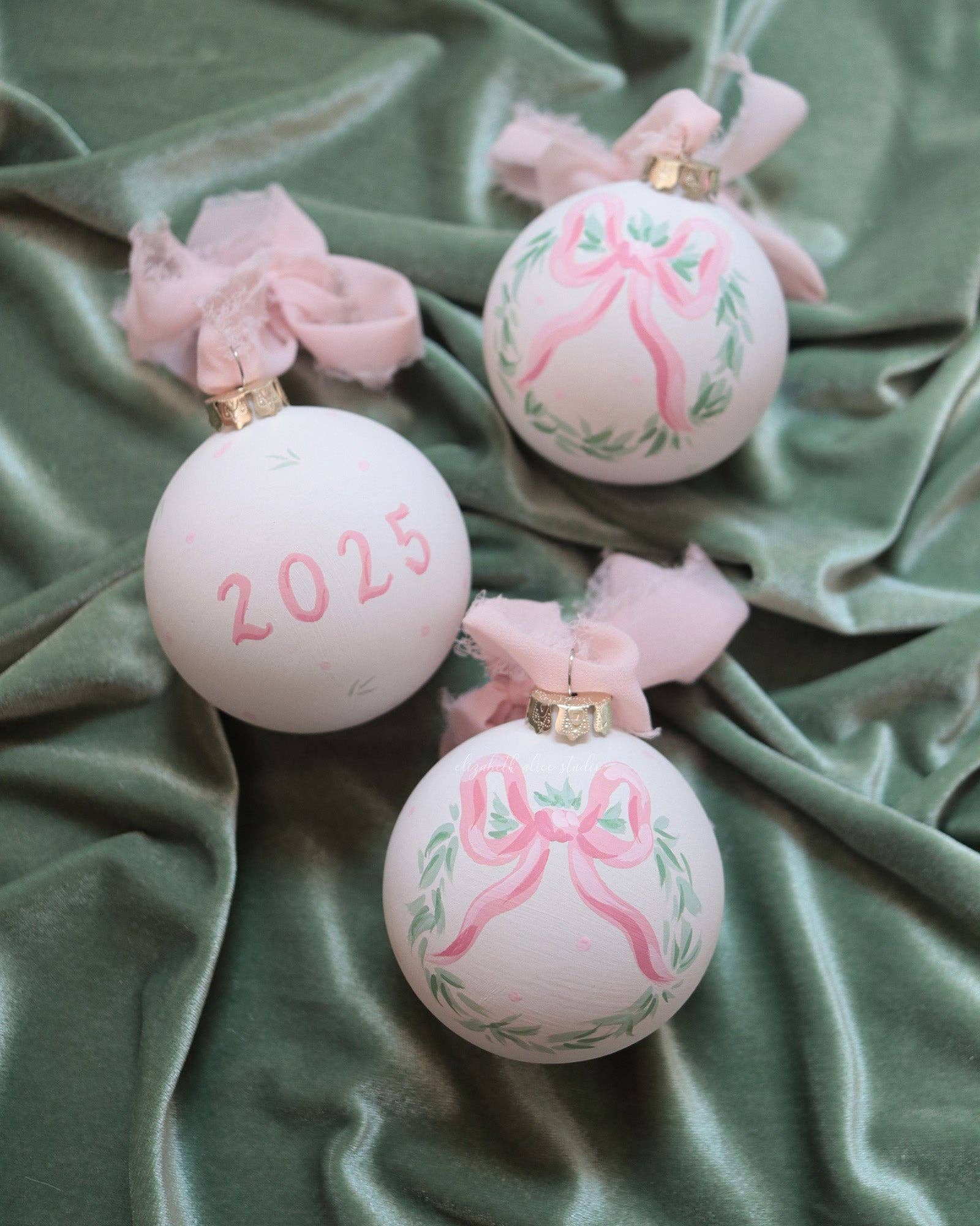 2025 pink bow wreath hand-painted ornament: No year (dots and leaves on reverse)
