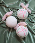 2025 pink bow wreath hand-painted ornament: No year (dots and leaves on reverse)
