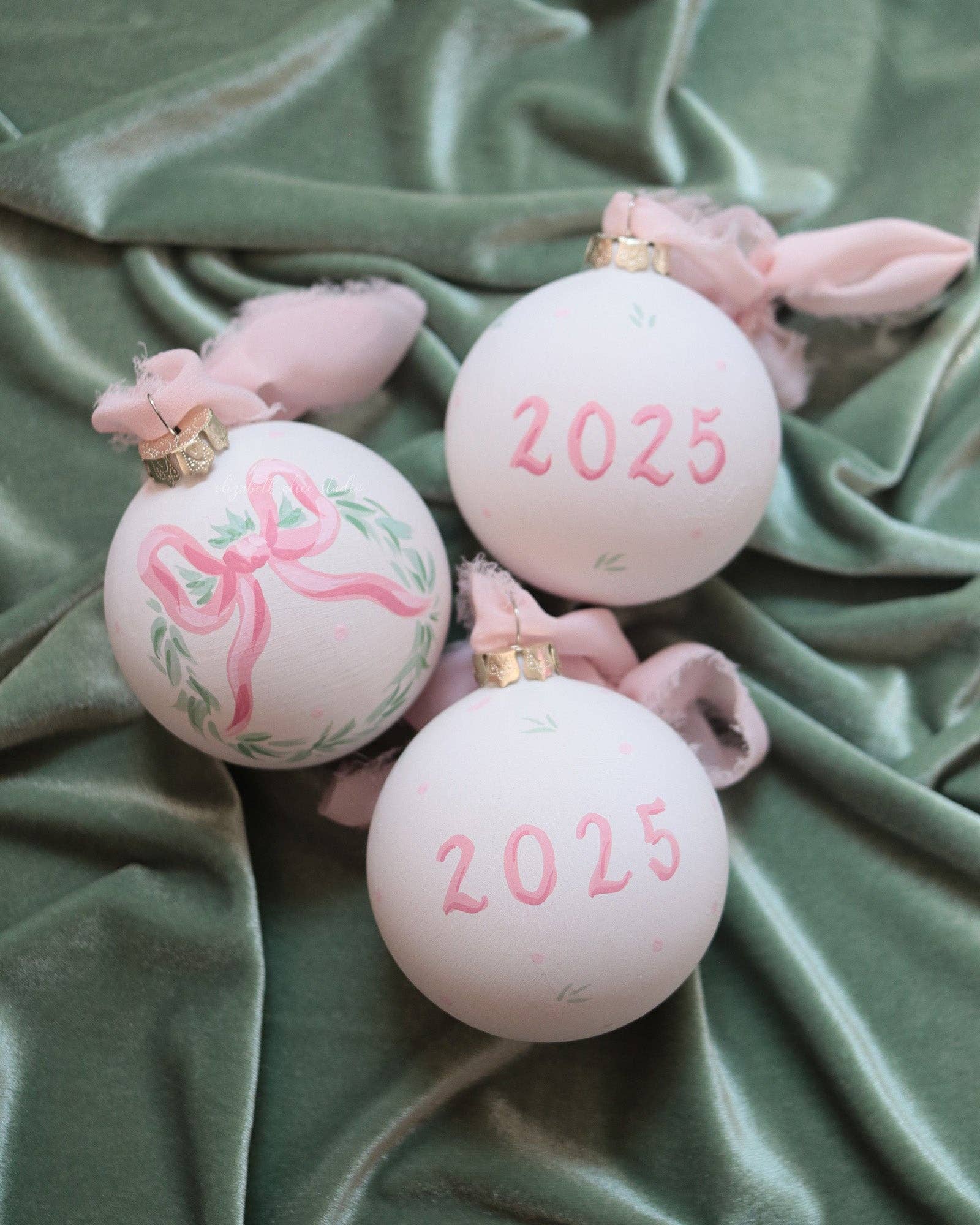 2025 pink bow wreath hand-painted ornament: No year (dots and leaves on reverse)